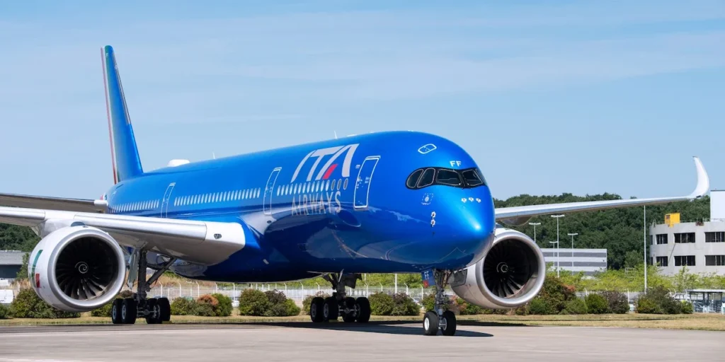 A striking blue ITA Airways Airbus A350 aircraft parked on an airport tarmac