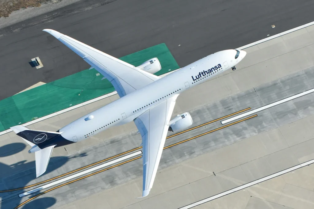 Overhead, high-angle view of a white Lufthansa Airbus A350 passenger airplane