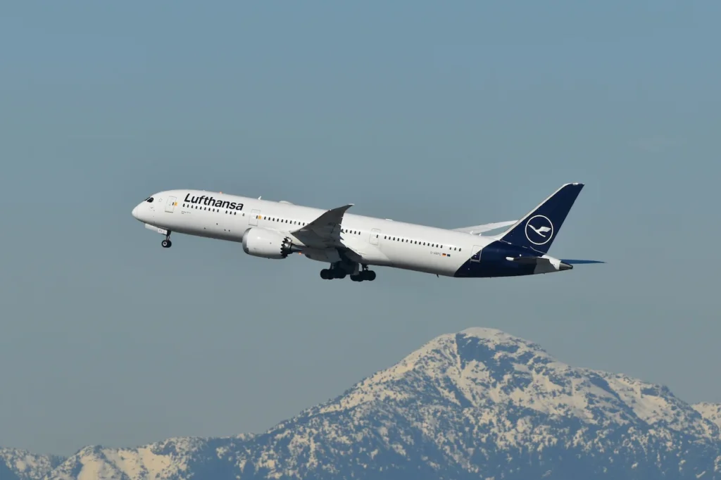 Lufthansa Boeing 787-9 Dreamliner taking off with mountains in the background