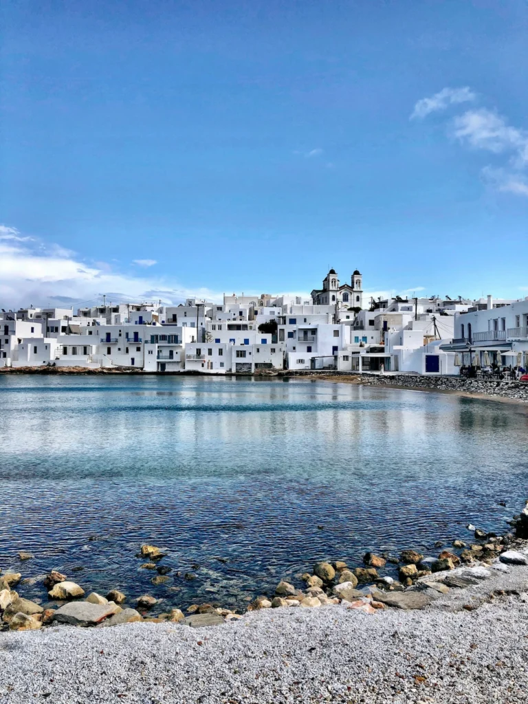 White buildings of Naoussa village in Paros overlooking the calm blue bay