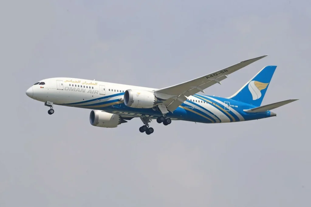 An Oman Air Boeing 787 Dreamliner aircraft with landing gear down mid-flight