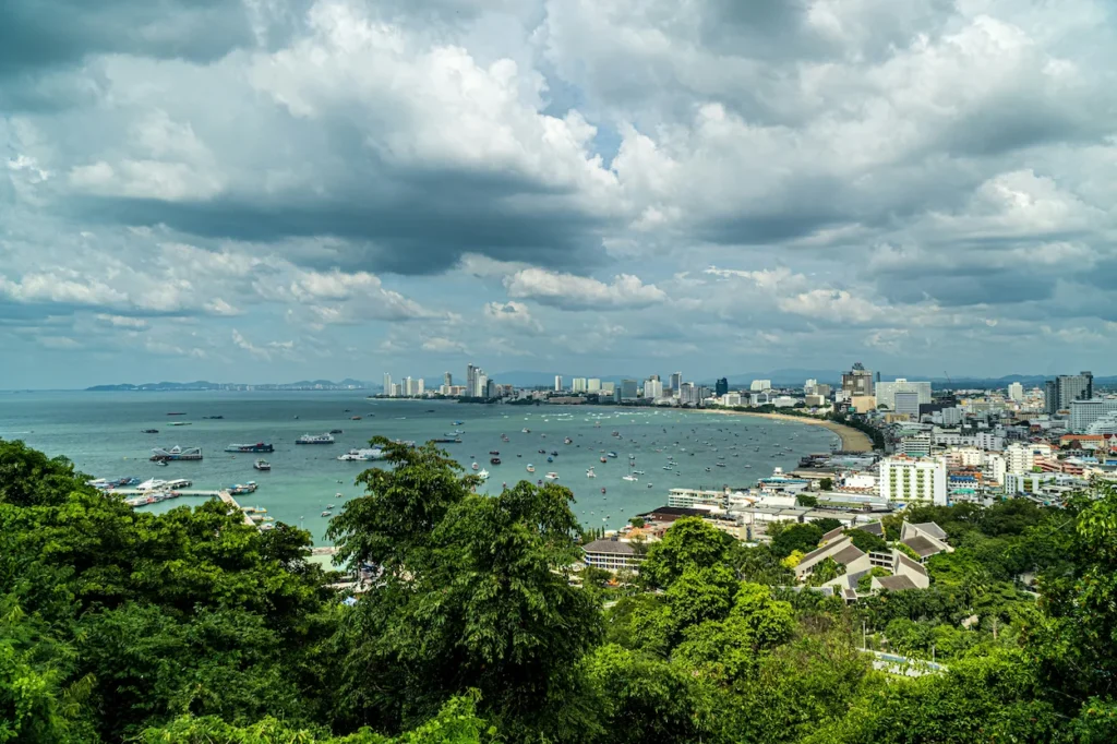 High-angle view of the curved Pattaya Bay filled with boats from Phra Tamnak Mountain viewpoint