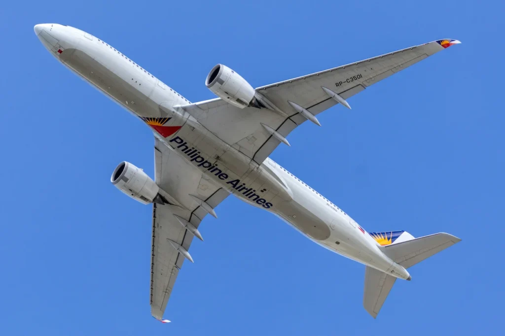 Underside view of Philippine Airlines Airbus A350 with tail number RP-C3501 flying in the sky over the Philippines