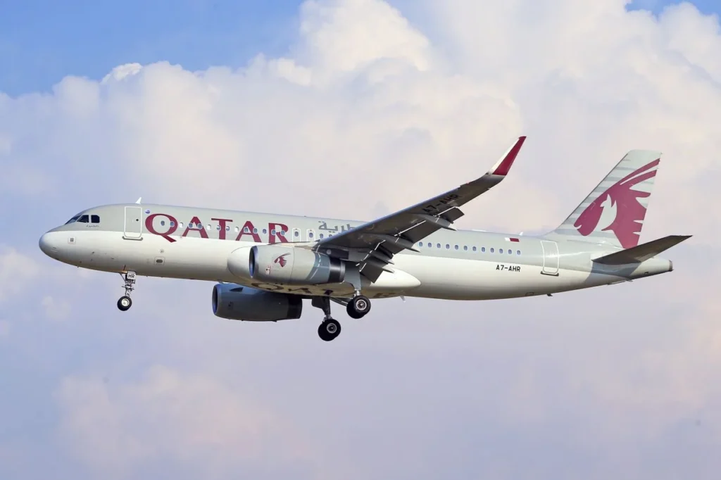 Qatar Airways Airbus A320 passenger aircraft cruising through the sky