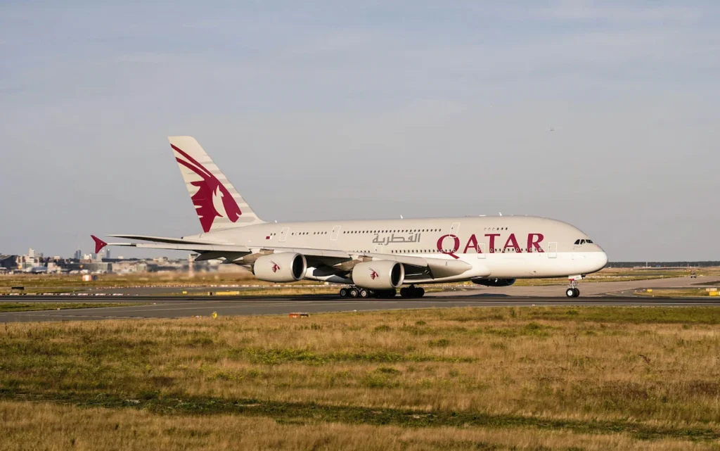 A double-decker Qatar Airways Airbus A380 passenger aircraft taxiing along a runway