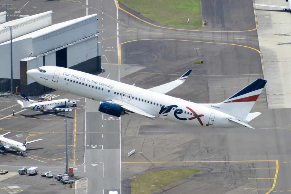Aerial view of a Rex Airlines Boeing 737 plane taking off from an airport runway