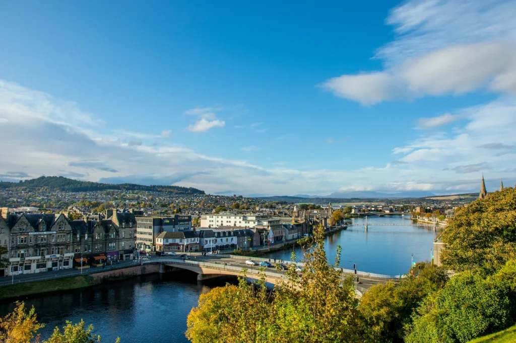 High-angle view of the River Ness and Ness Bridge in Inverness under a bright blue sky