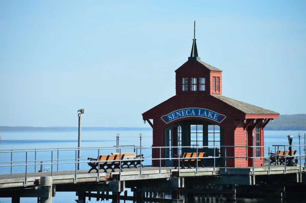 Historic red pier pavilion and wooden benches on Seneca Lake in Geneva, New York
