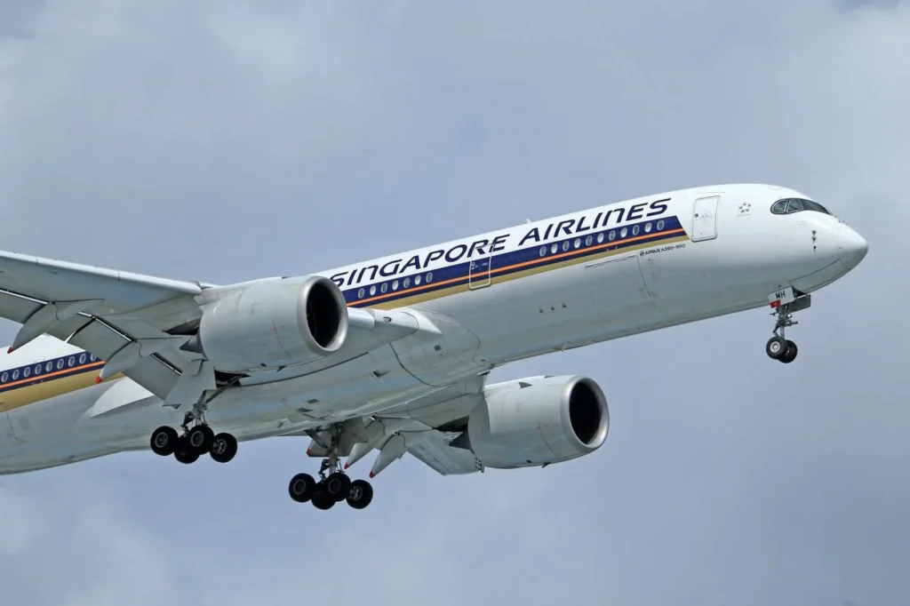 Singapore Airlines Airbus A350-900 passenger airplane descending through a cloudy sky