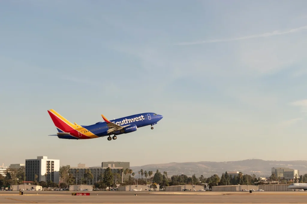 Southwest Airlines Boeing 737 jet taking off over a city landscape