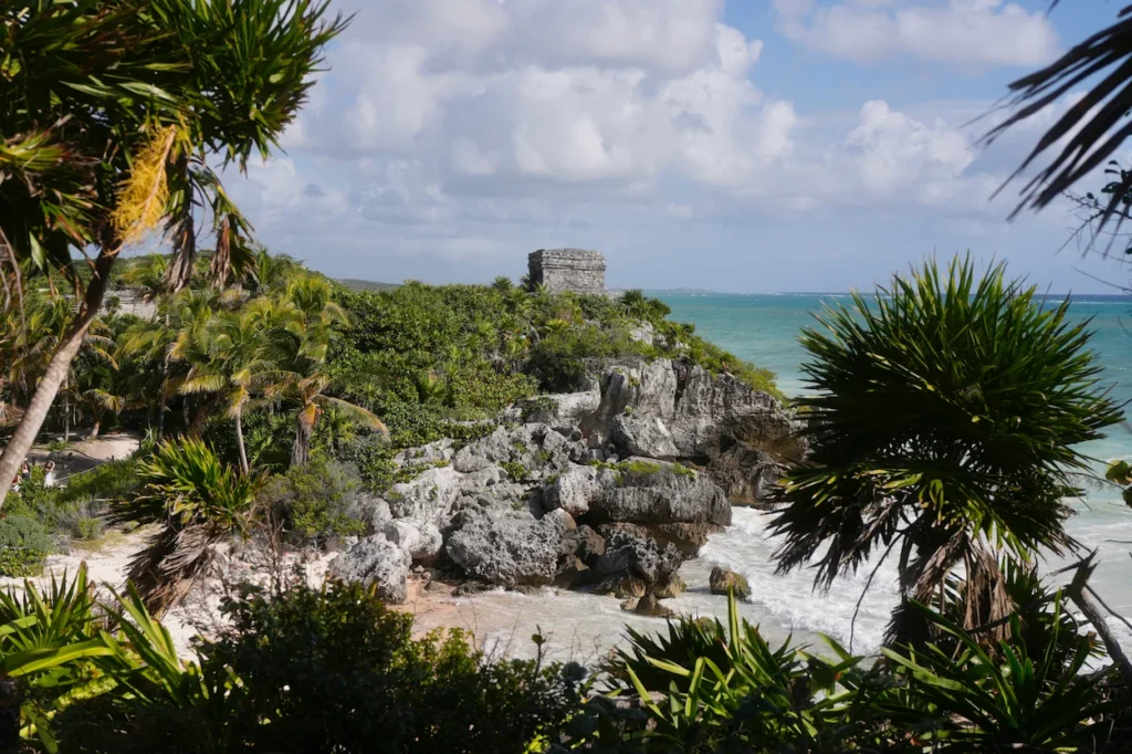 Ancient Mayan ruins on a rocky cliff overlooking a turquoise ocean in Tulum