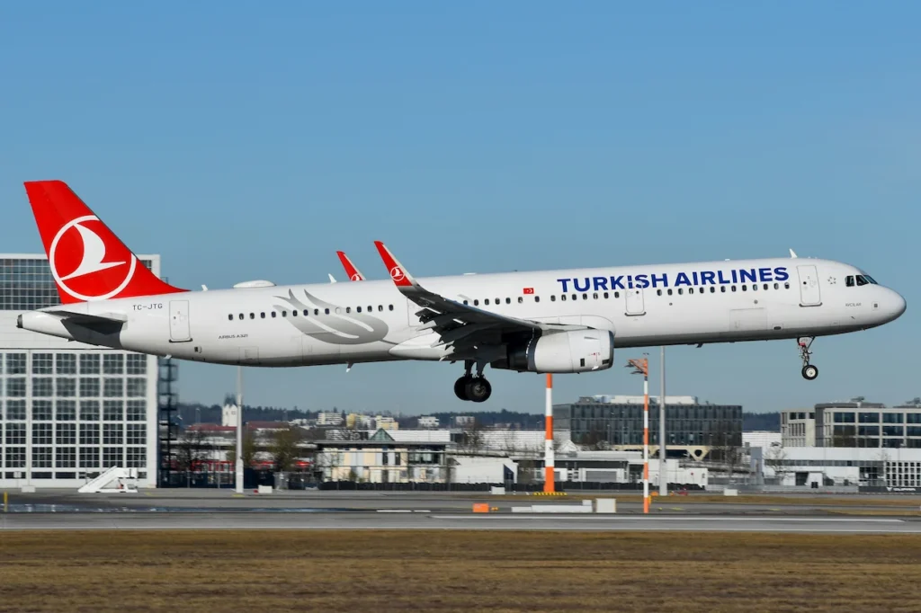 Turkish Airlines Airbus A321 passenger airplane with landing gear extended approaching the runway