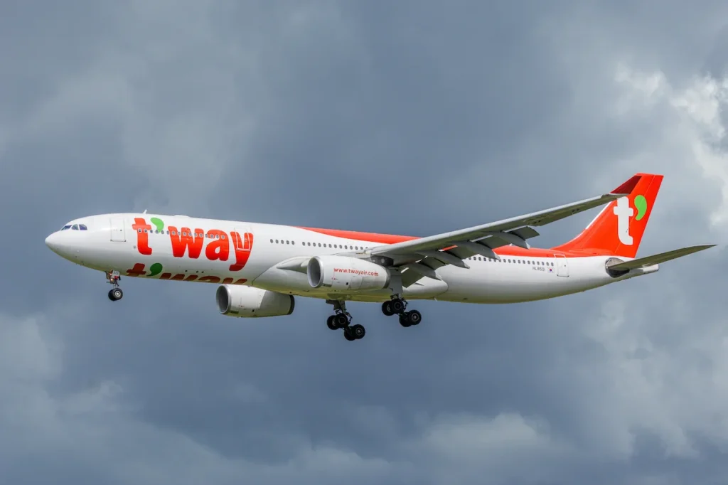 T'way Air Airbus A330 passenger airplane preparing to land under a cloudy sky