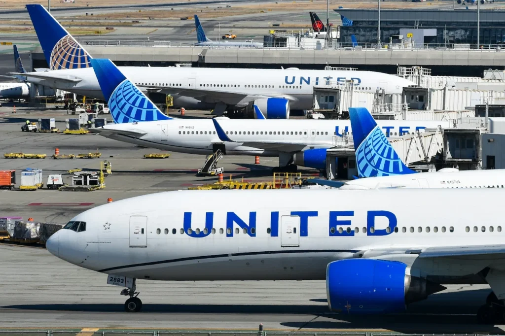 United Airlines passenger airplanes parked at adjacent terminal gates