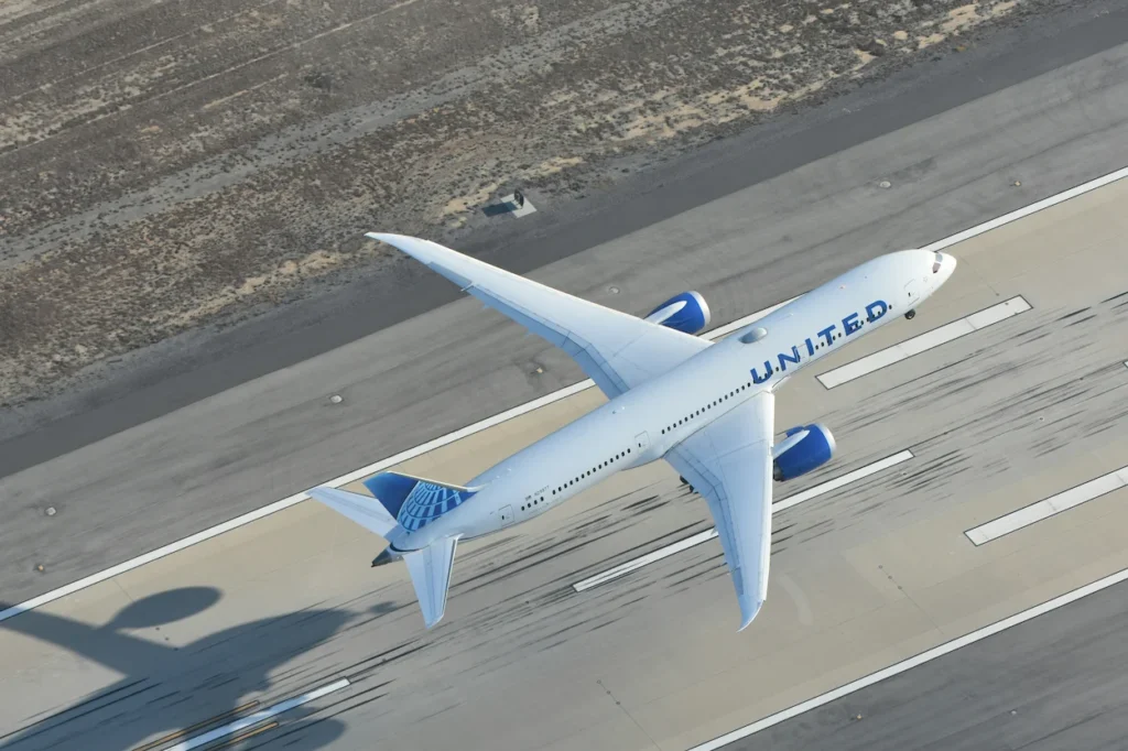 An aerial bird's-eye view of a white United Airlines Boeing 787-9 Dreamliner passenger airplane