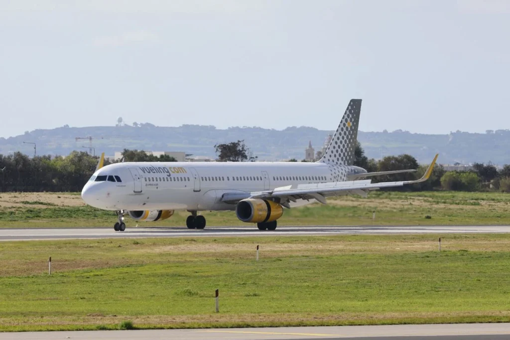 Vueling Airlines Airbus A321 passenger airplane taxiing on an airport runway tarmac