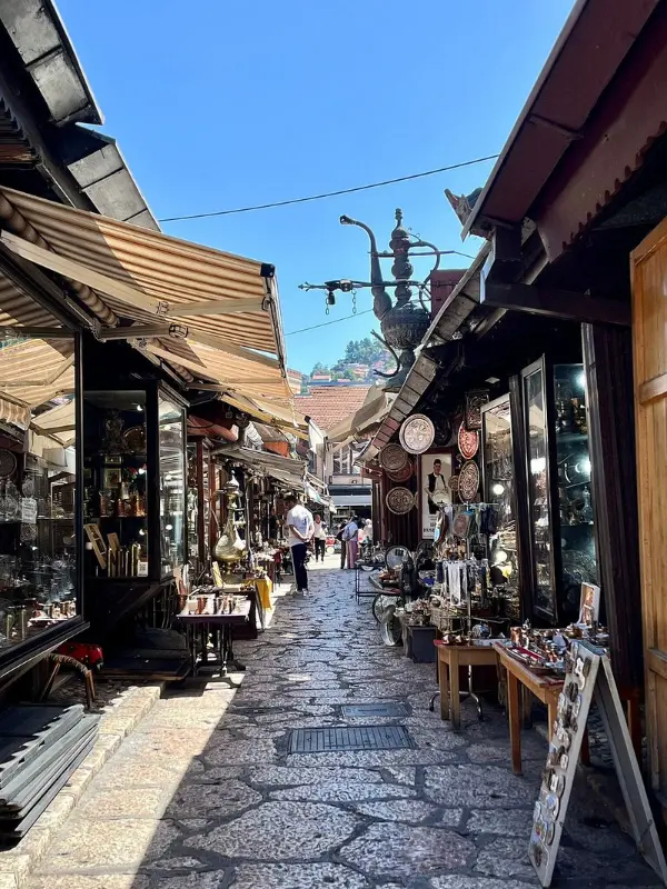 Narrow stone street with shops at Baščaršija market.