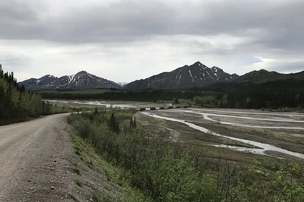 The Teklanika River winding through a wide valley with snowy peaks in the distance.