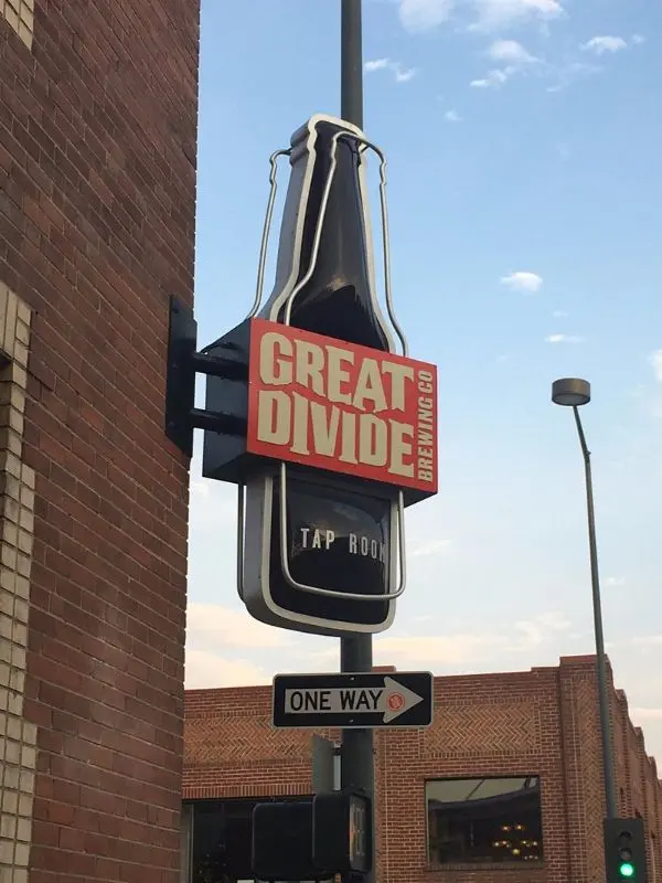 A bottle-shaped sign marks the entrance to Great Divide Brewing Co tap room.