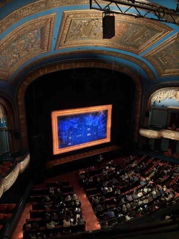 Audience seated inside the ornate Curran Theatre before a show.
