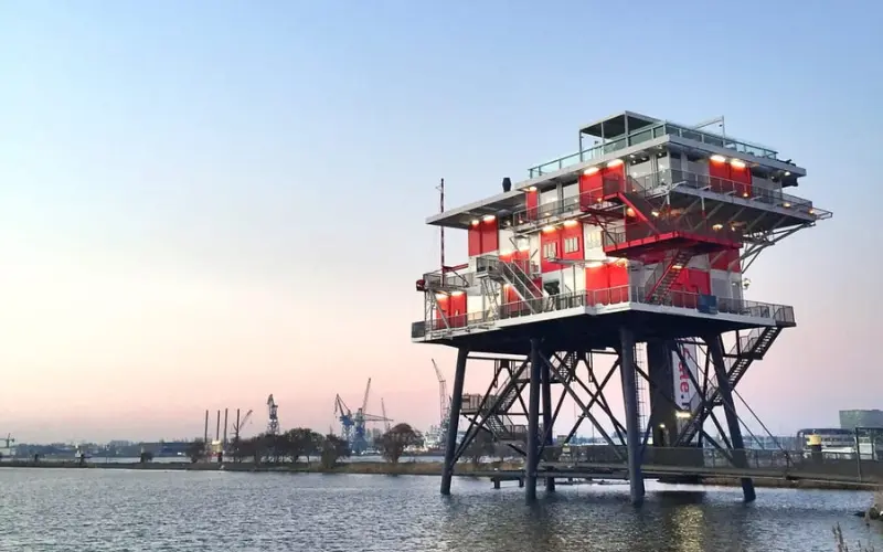 REM Eiland restaurant on a raised offshore platform above the water.