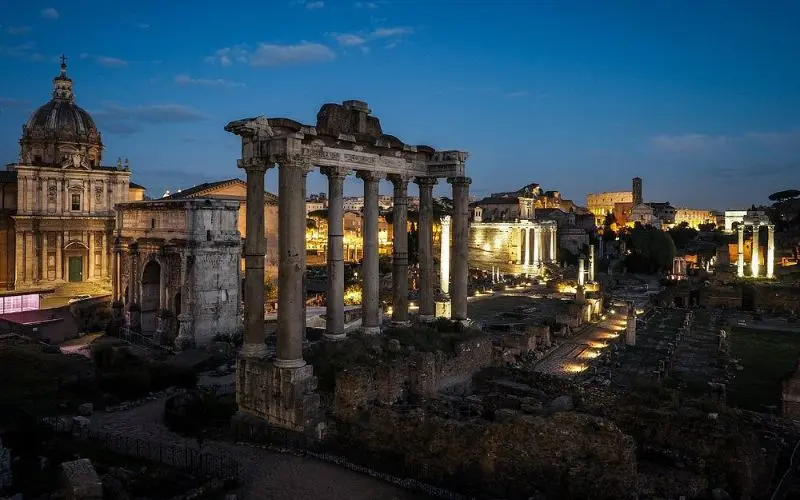 Roman Forum in Rome, Italy with ancient ruins at dusk.