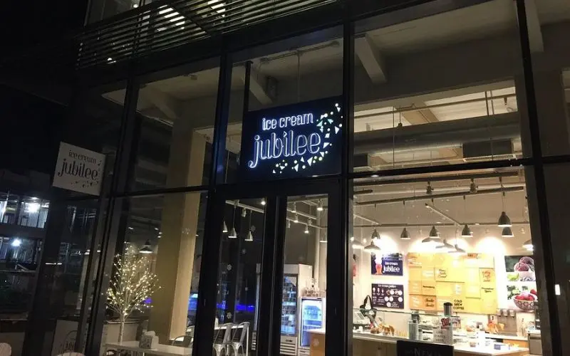 The Ice Cream Jubilee shop lit up at night in Washington, DC.