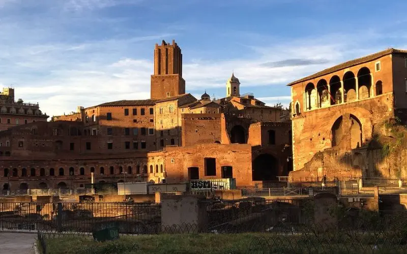Monti district in Rome, Italy with historic brick buildings at sunset.