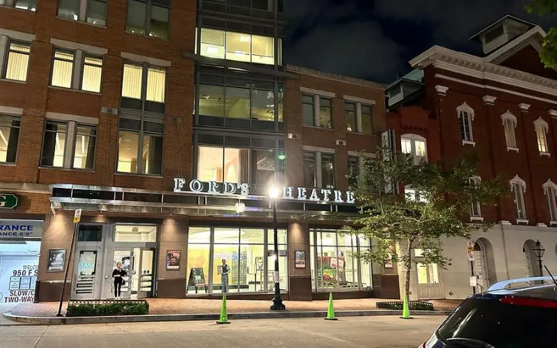 The front entrance of Ford’s Theatre lit up at night in Washington, DC.
