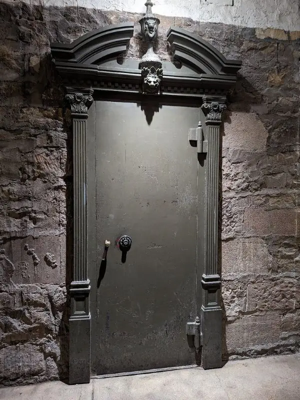 A heavy old metal door is shown on the Dark Side of Denver Ghost Tours.