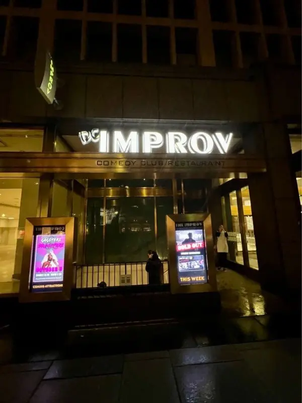 The entrance of the DC Improv Comedy Club at night.