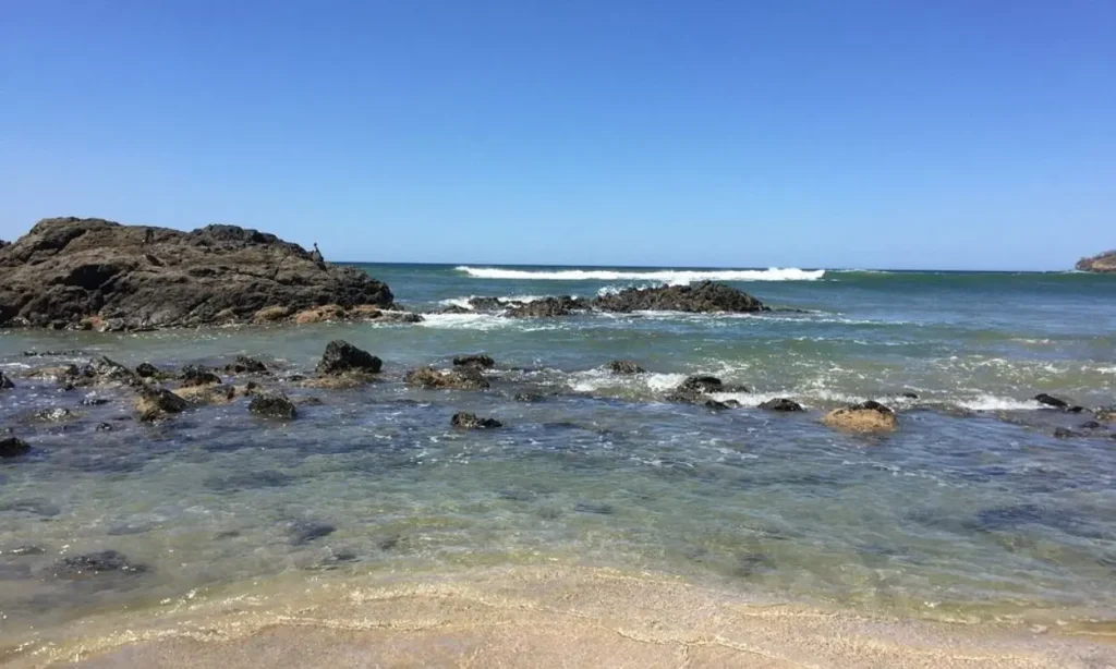 Rocky shoreline and clear blue water at Las Baulas National Marine Park.
