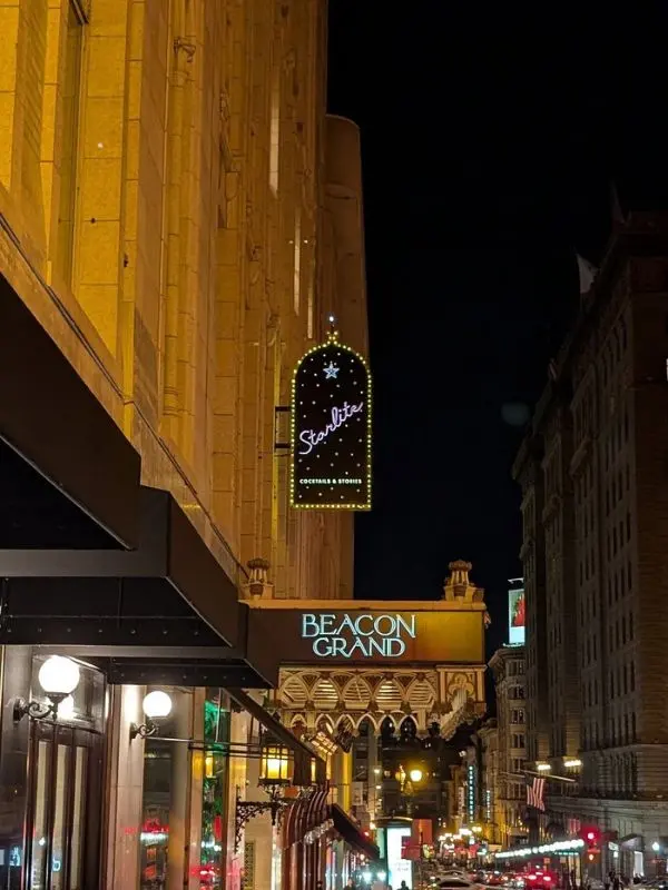 Neon sign of Starlite above the Beacon Grand at night.