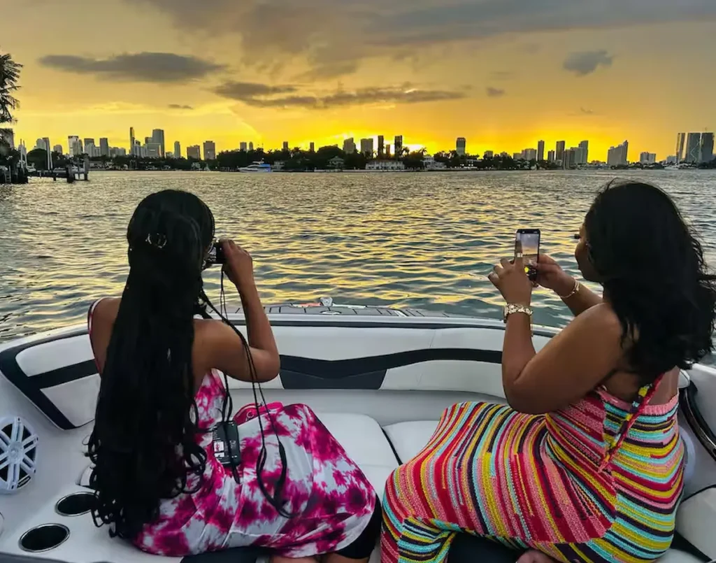 Observe Miami's night skyline from the water