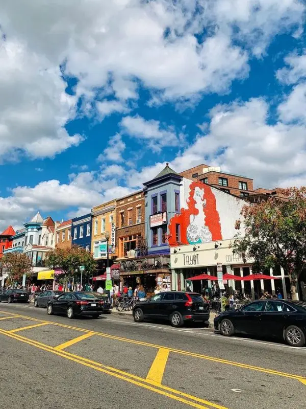 Colorful buildings and shops line the street in Adams Morgan, Washington, DC.