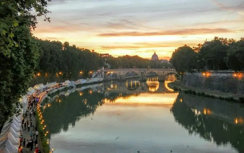 Trastevere in Rome, Italy with Tiber River and sunset view.