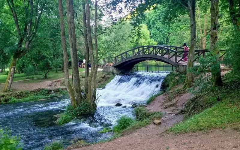 Wooden bridge over a small waterfall at Vrelo Bosne.