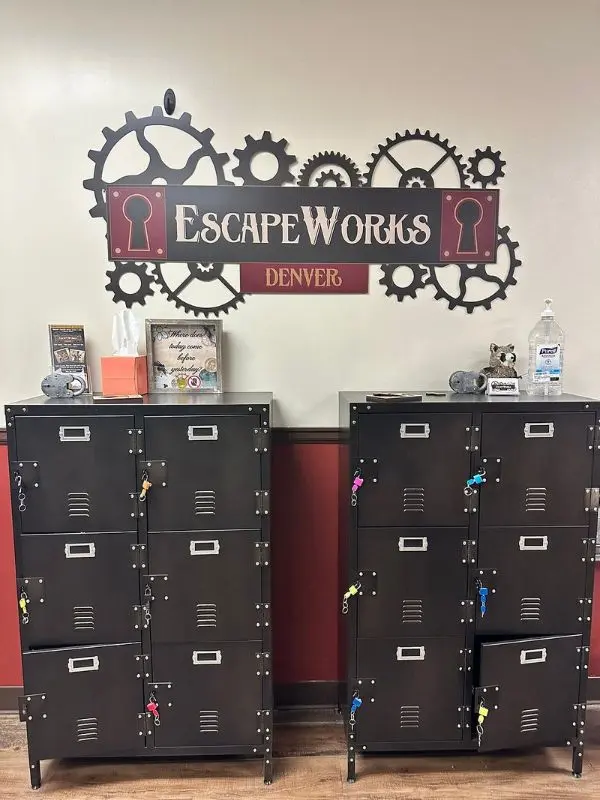 Lockers sit beneath a wall sign that reads EscapeWorks Denver.