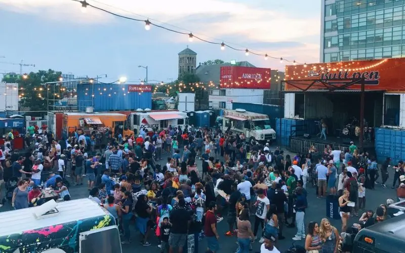 A large crowd gathers around food trucks at Truckeroo in Washington, DC.