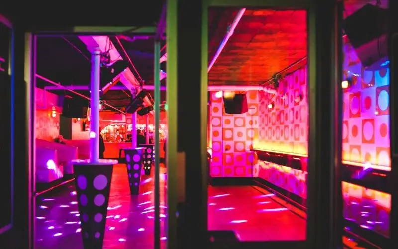 Colorful lights glow inside the Milk Bar nightclub in Denver.