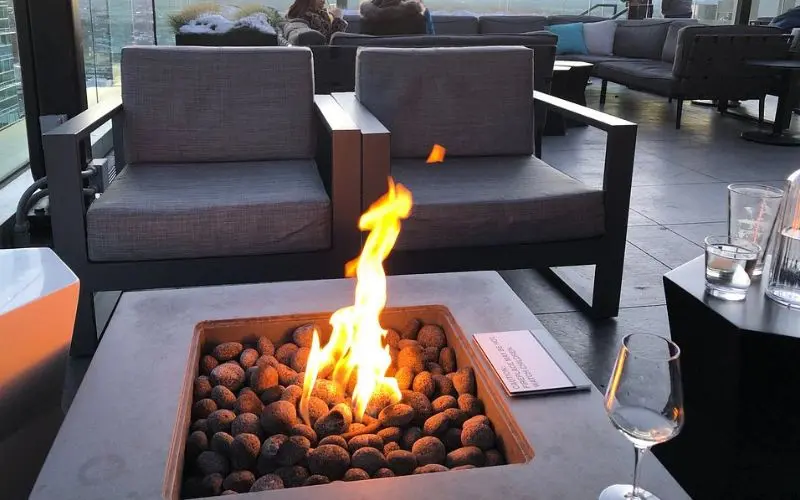 A fire pit burns on the patio at 54thirty Rooftop bar.