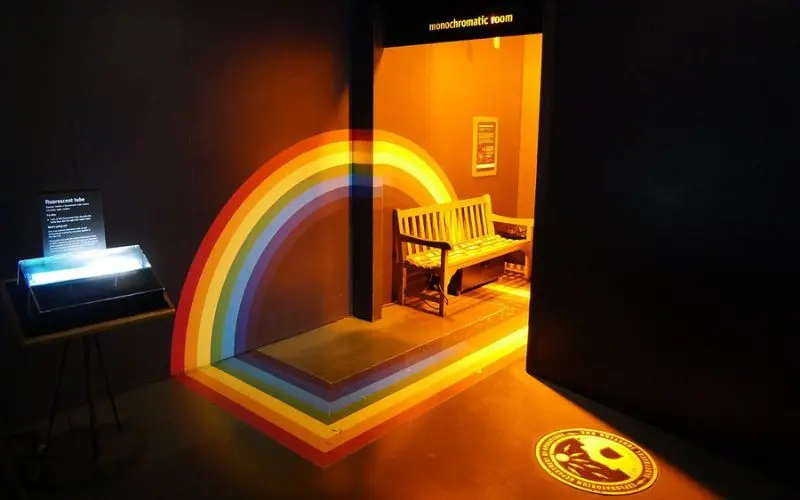 Rainbow light display and monochromatic room at the Exploratorium.
