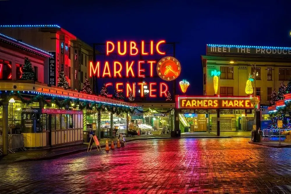 The neon signs of Pike Place Market in Seattle at night.
