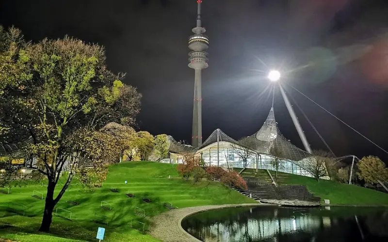 The Olympic Tower and stadium at Olympiapark in Munich at night.