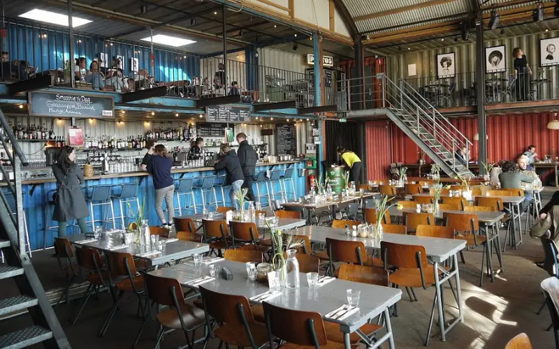 Industrial-style dining hall inside Pllek restaurant and bar.