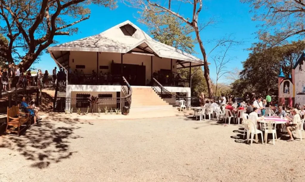 People gathered outside Tamarindo Church on a bright sunny day.