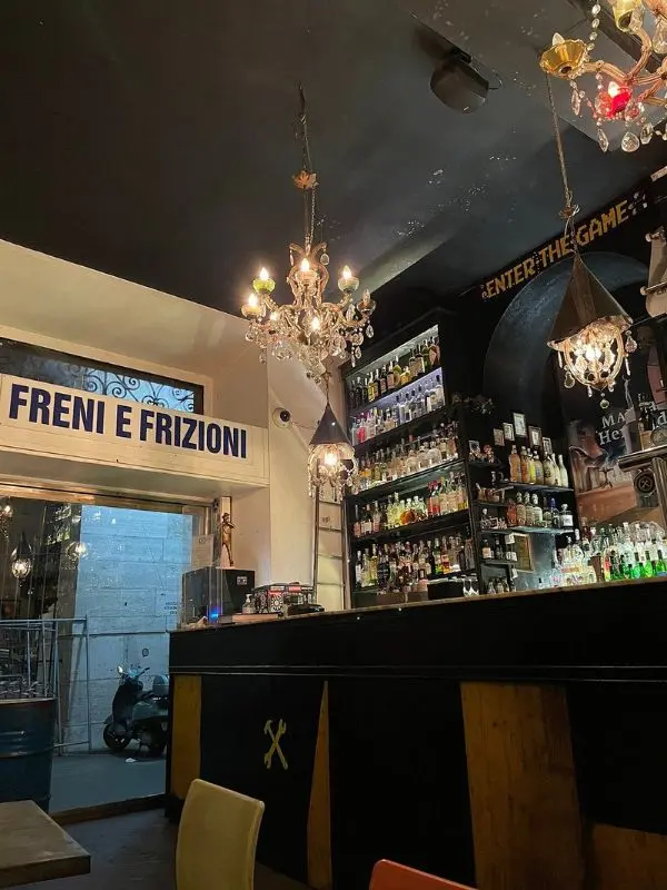 Freni e Frizioni bar in Rome, Italy with chandeliers and bottles.