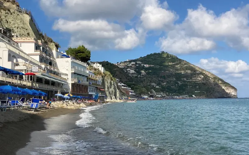Beachfront with umbrellas and hotels at Maronti Beach.