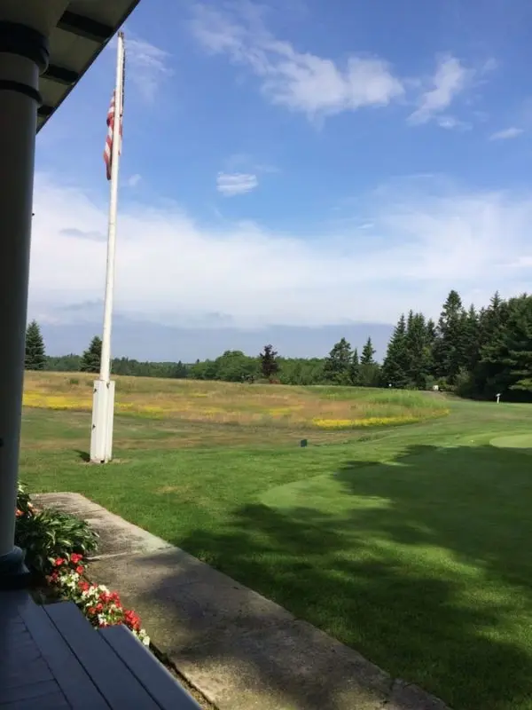 A grassy fairway stretches across Wawashkamo Golf Club.