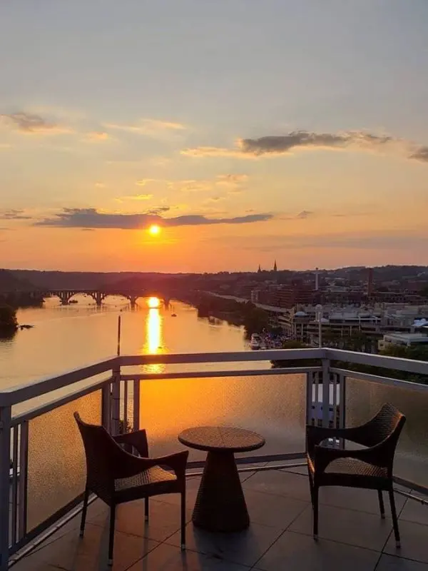 The Top of the Gate rooftop bar overlooks the Potomac River at sunset in Washington, DC.